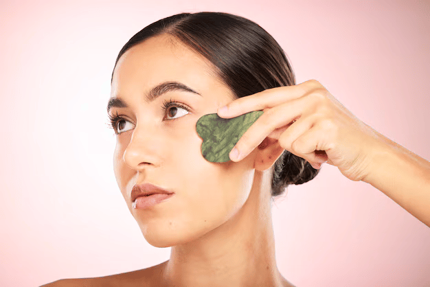 Facial gua sha massage with green jade tool